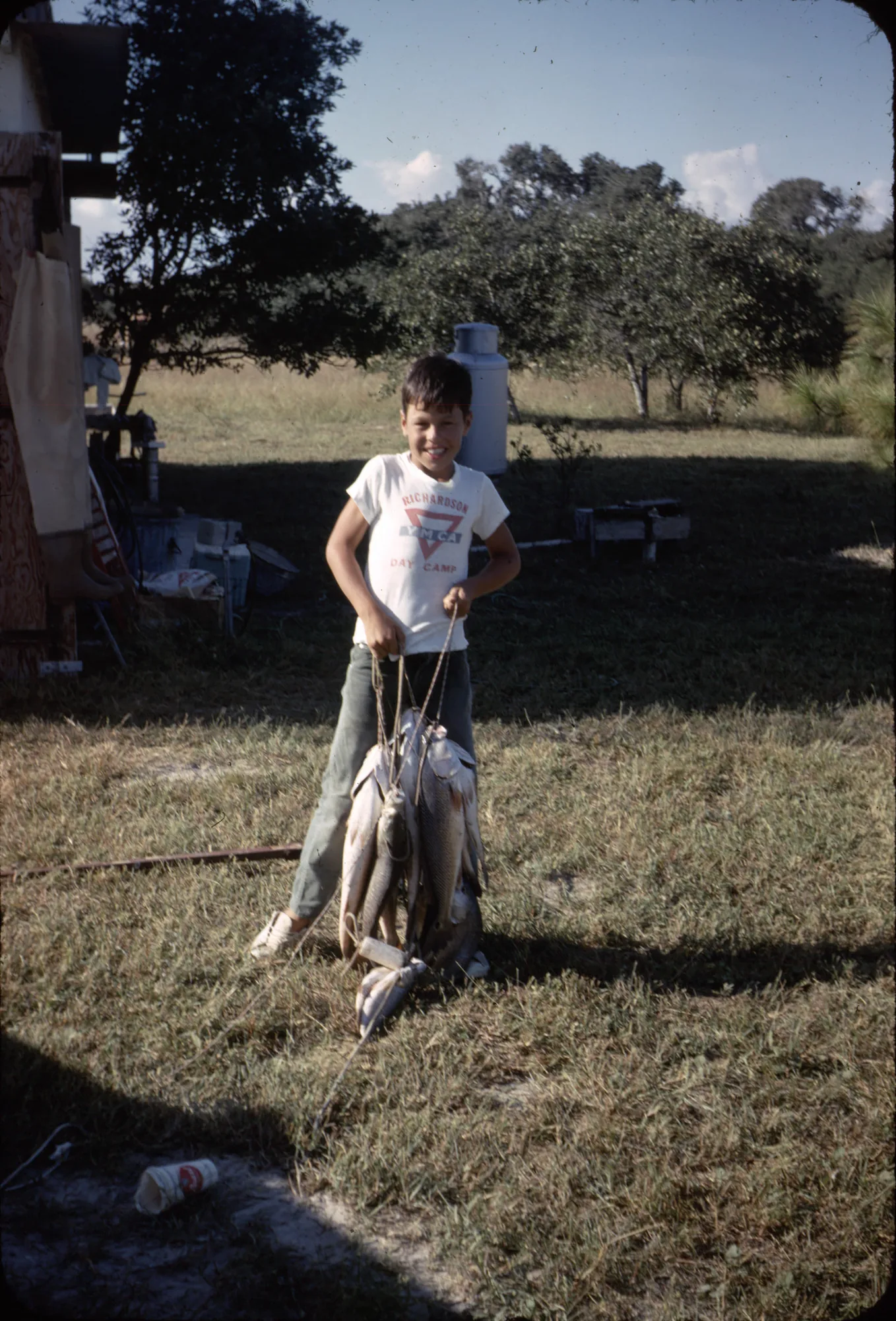 Young Jeff Givan holding a string of fish