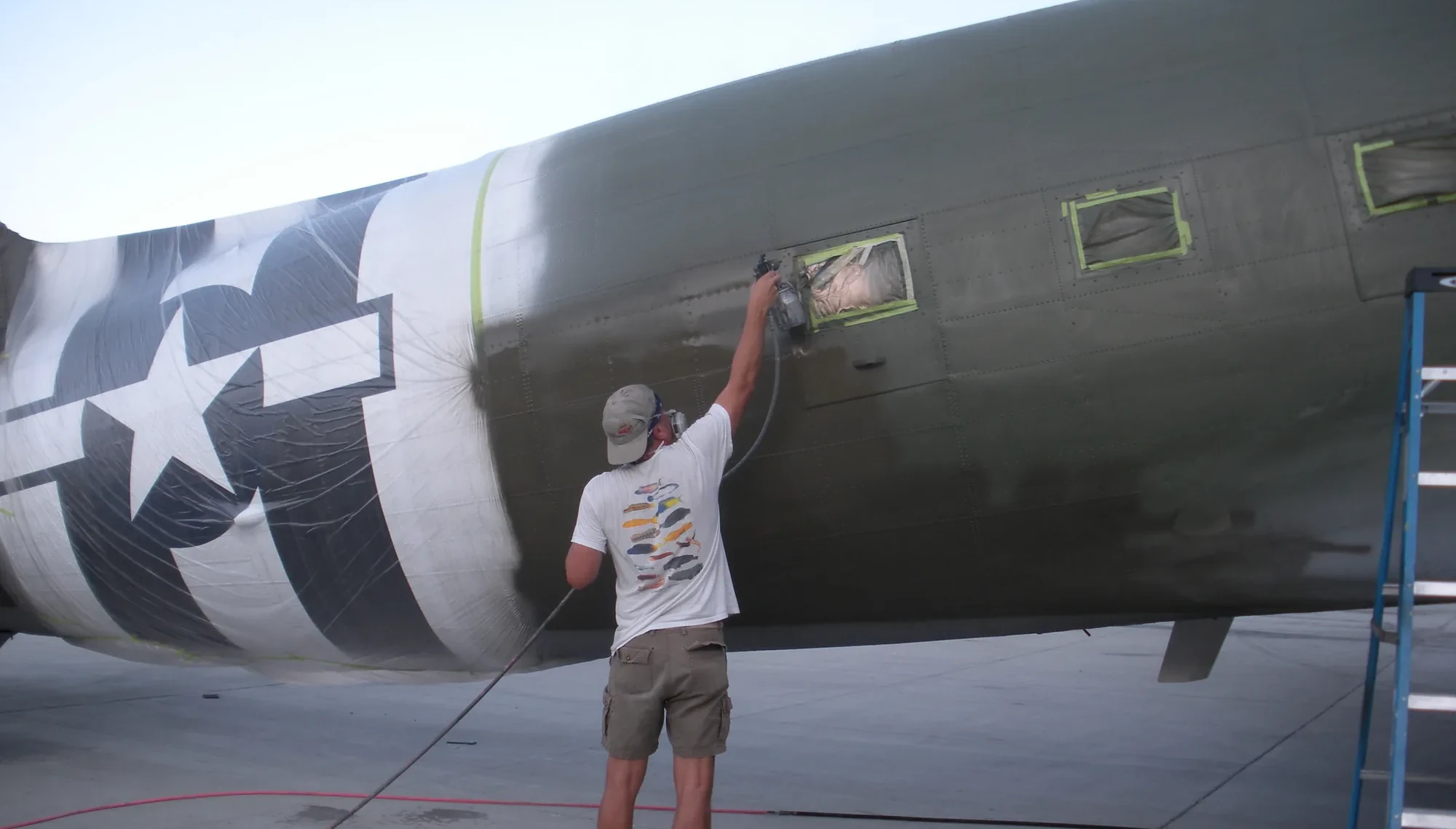 Jeff Givan painting a World War II aircraft